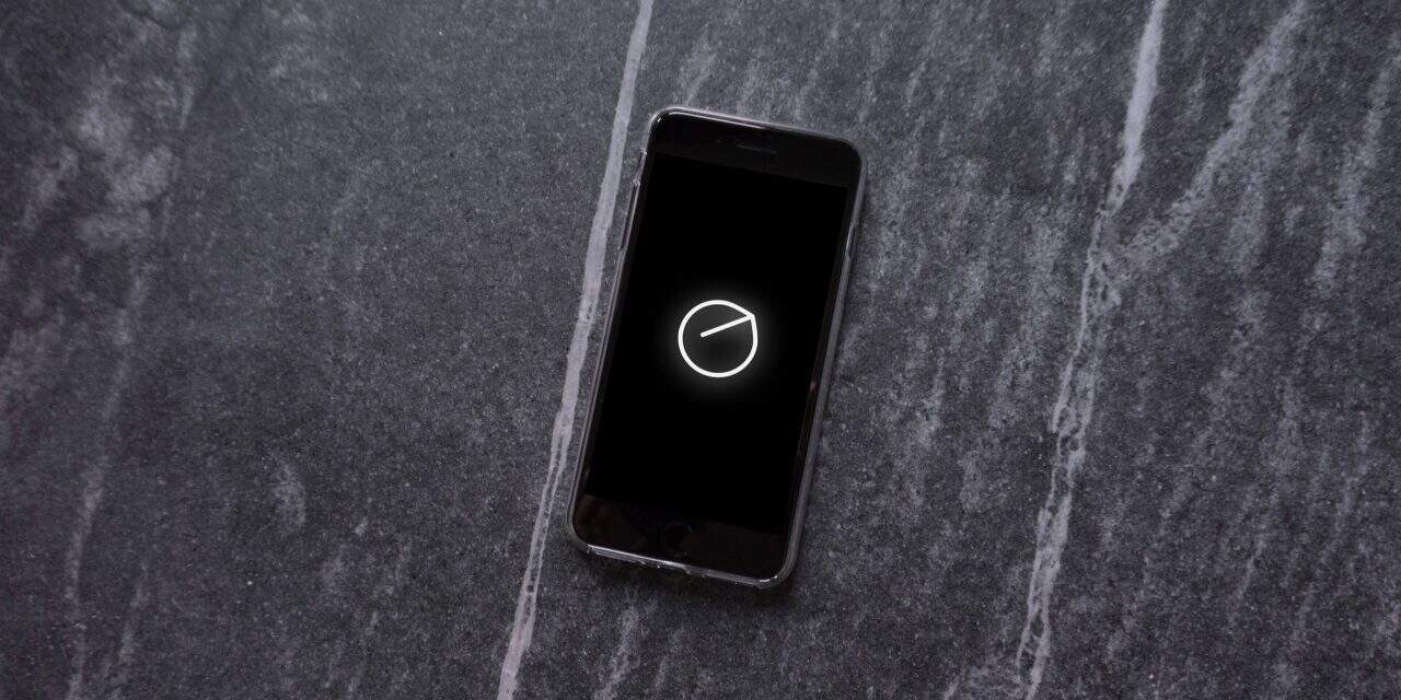 A smartphone displaying the Senstone Wearable logo on the screen