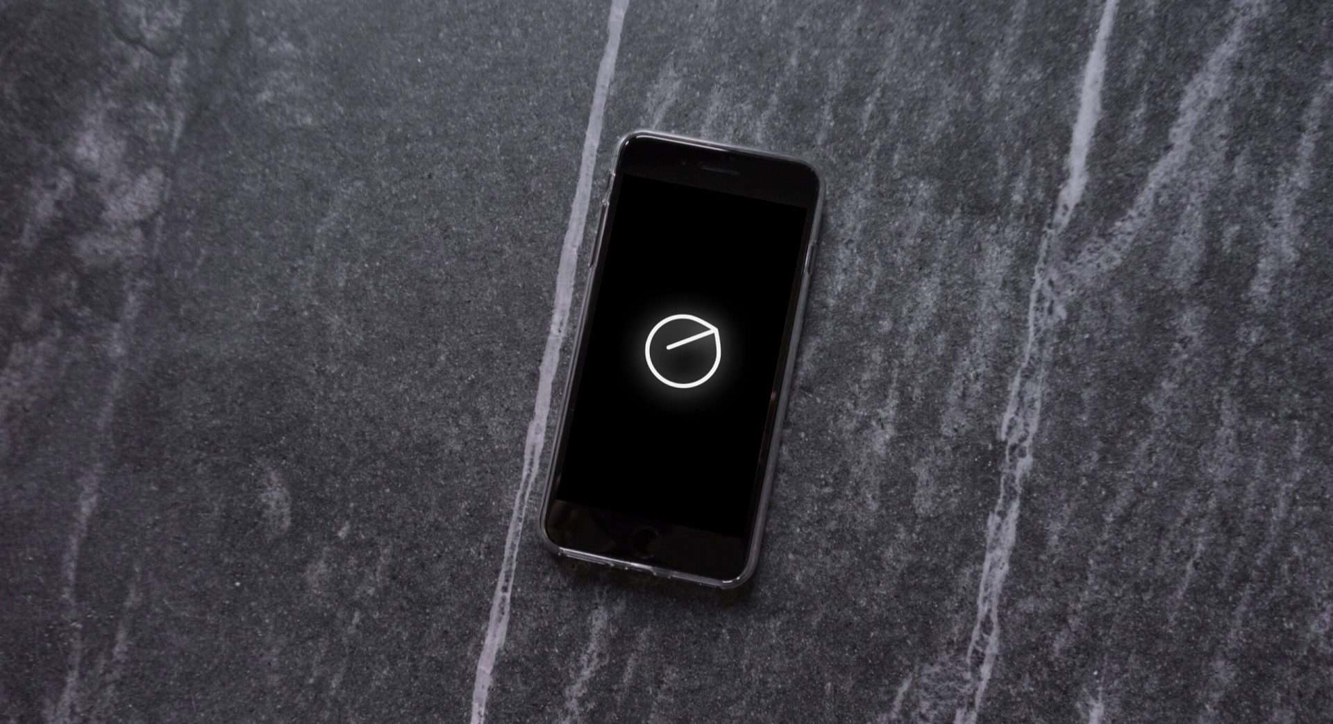 a smartphone displaying the senstone wearable logo on the screen