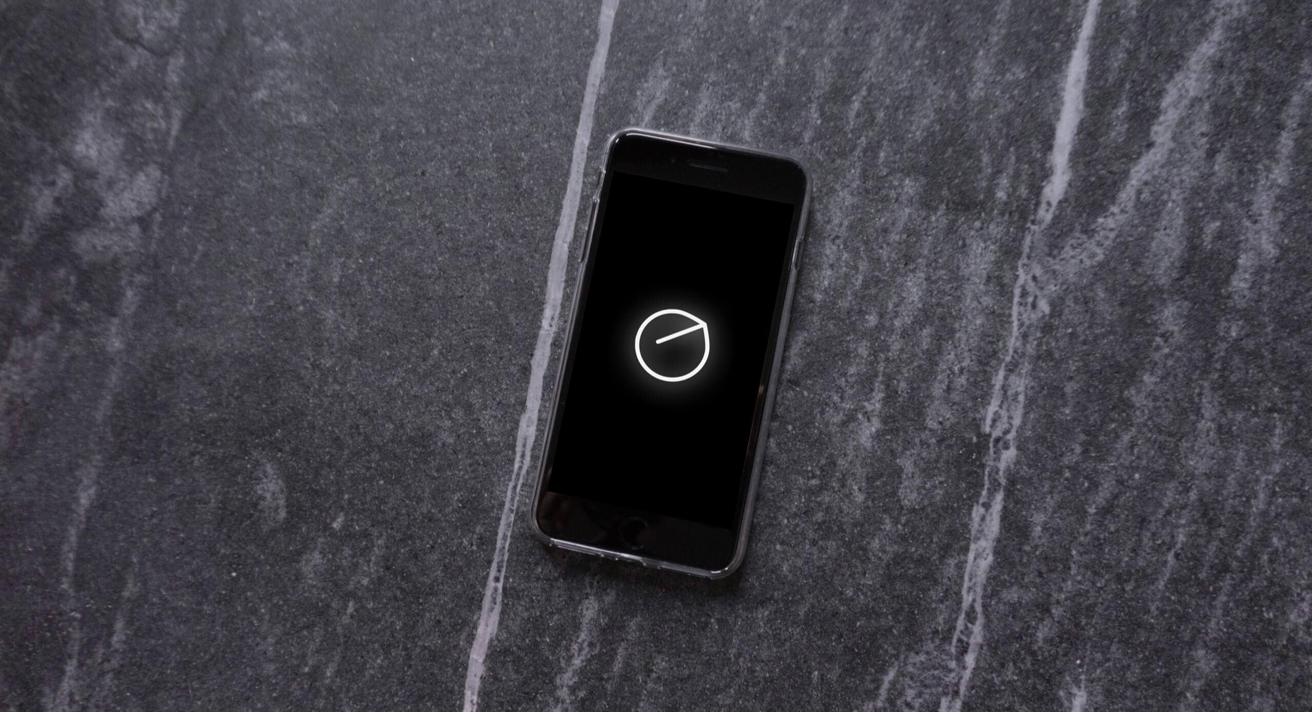 A smartphone displaying the Senstone Wearable logo on the screen