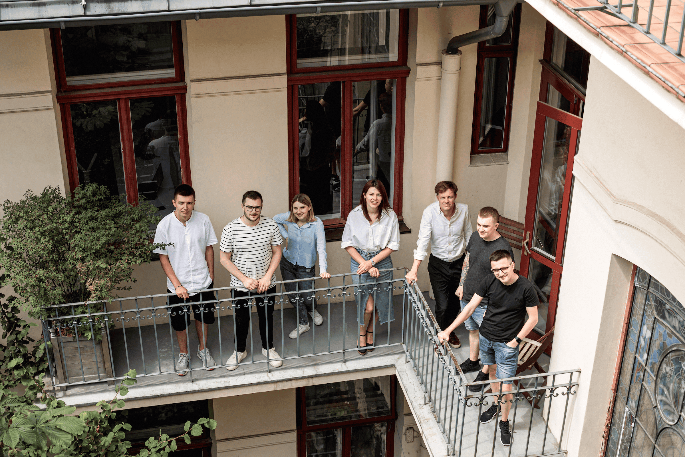 A group of people standing on a balcony.