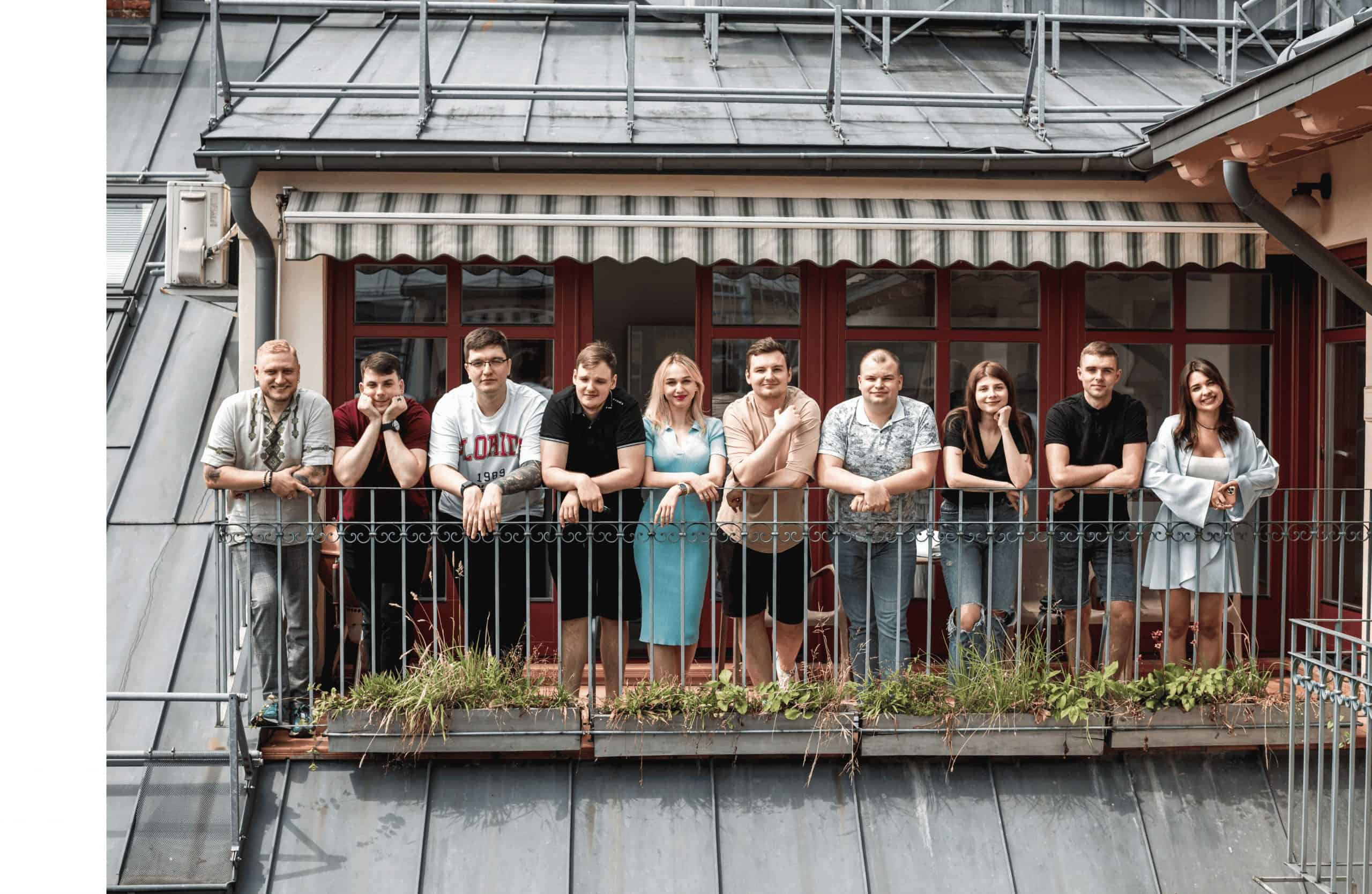 a group of people standing on a balcony.
