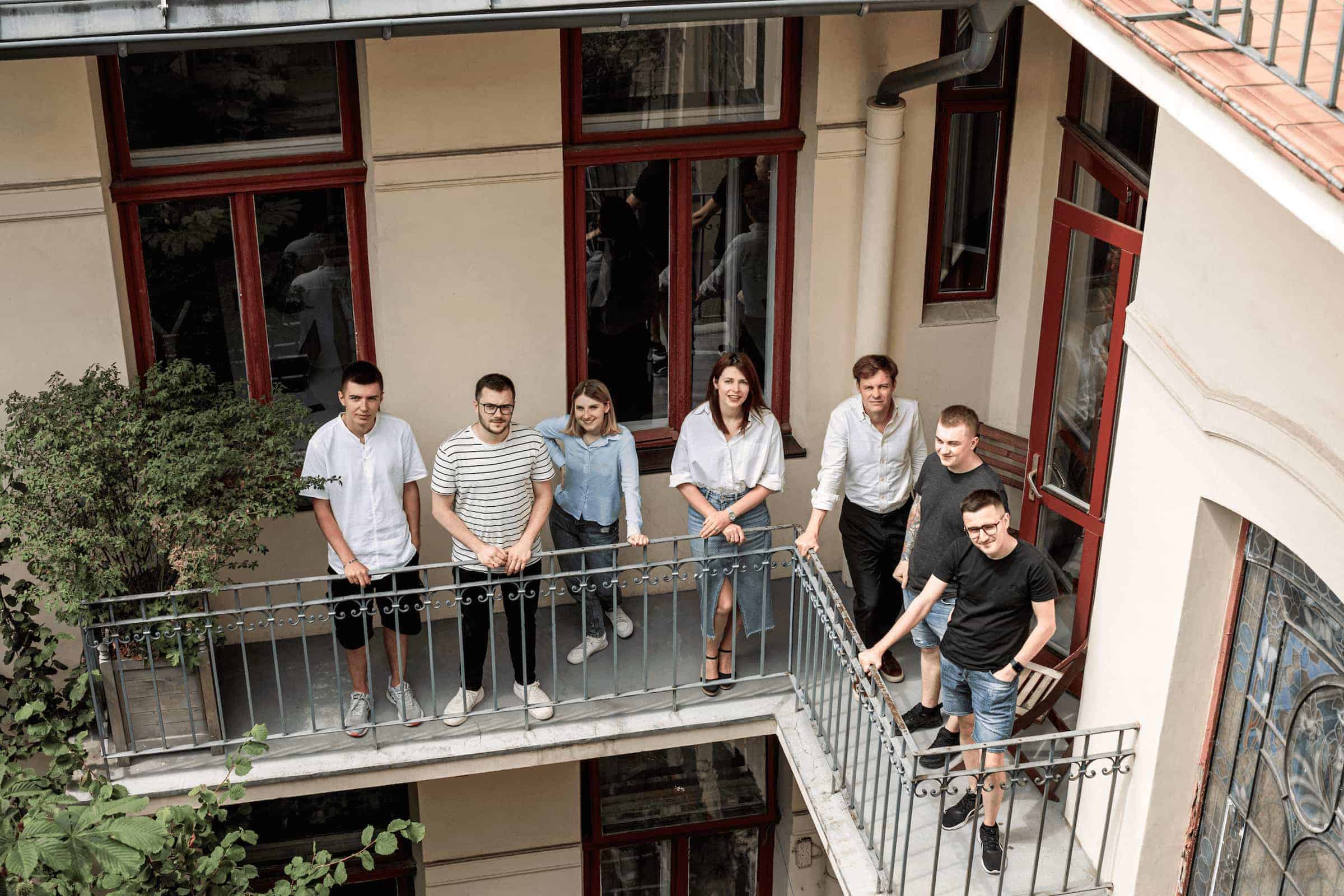 a group of people standing on a balcony.