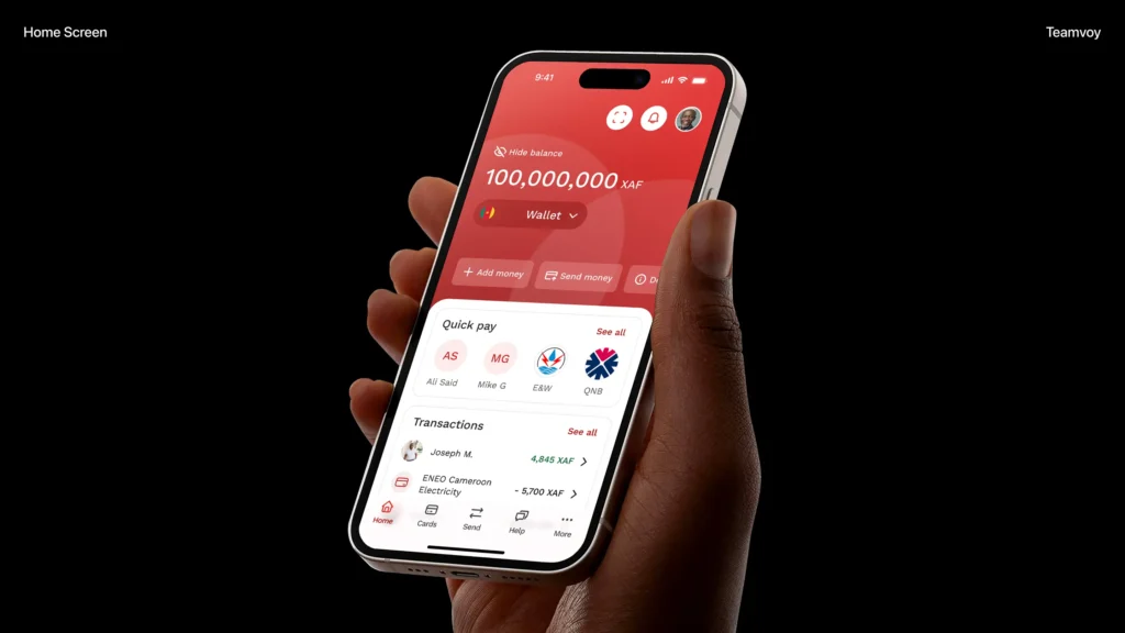 hand holding a smartphone displaying a red wallet app with balance 100,000,000 xaf and quick-pay options on a black background