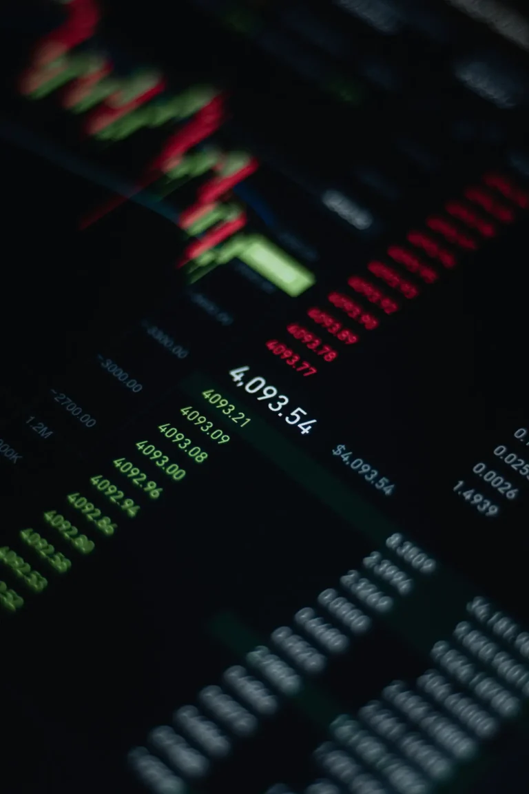 stock market ticker display with red declines and green gains on a dark screen.